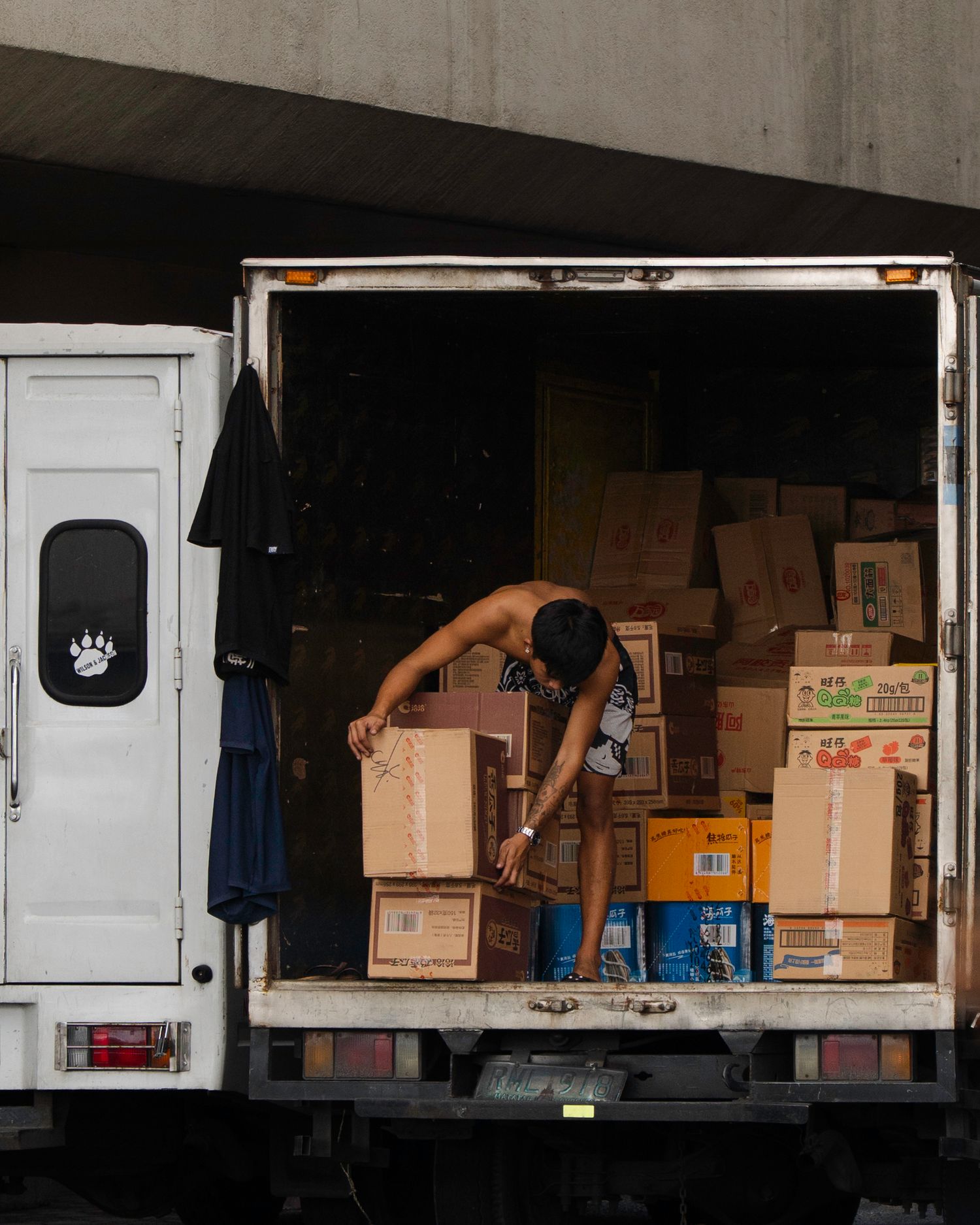 delivery worker organizing boxes in truck