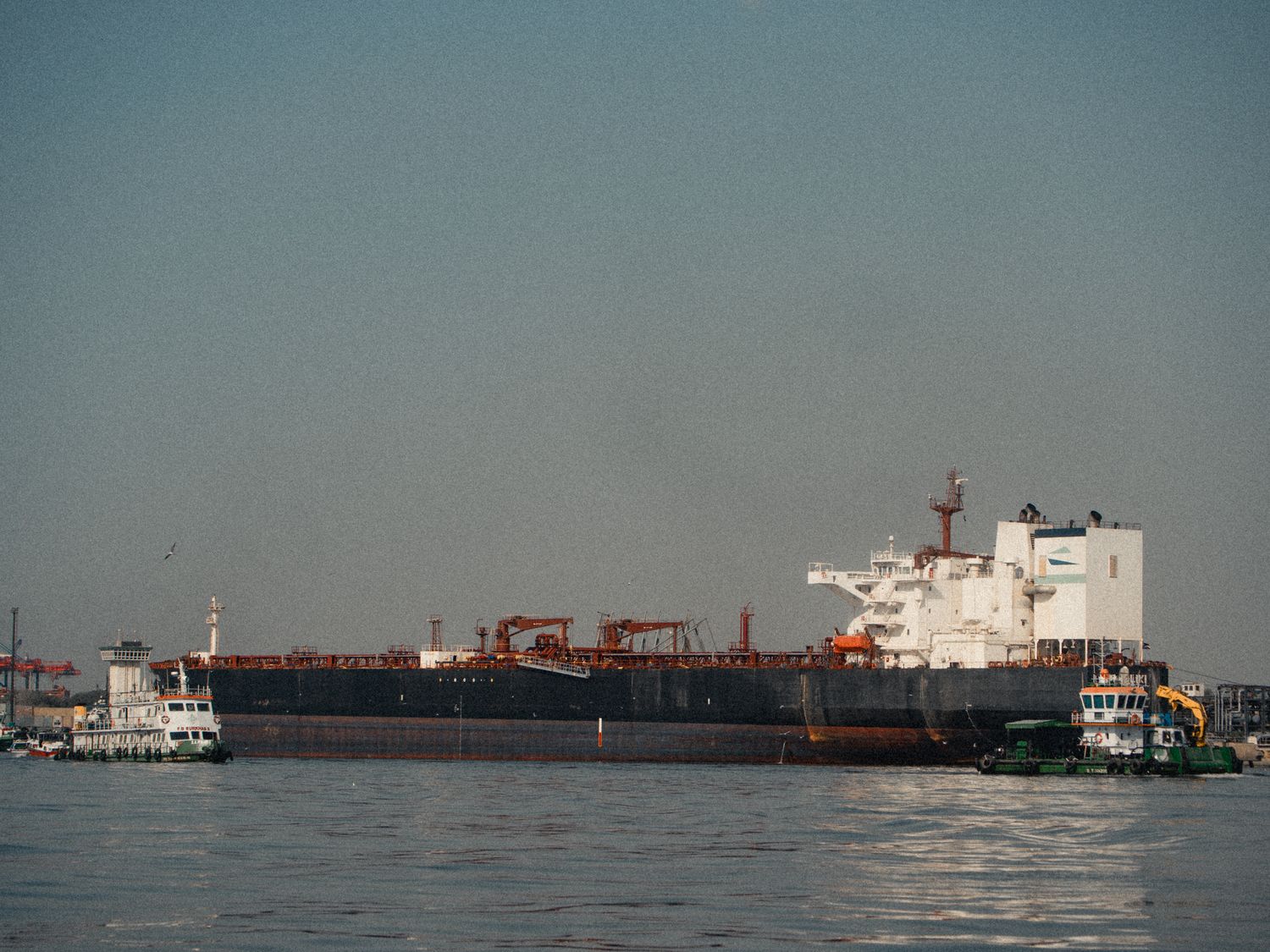 large cargo ship docked at port on a clear day