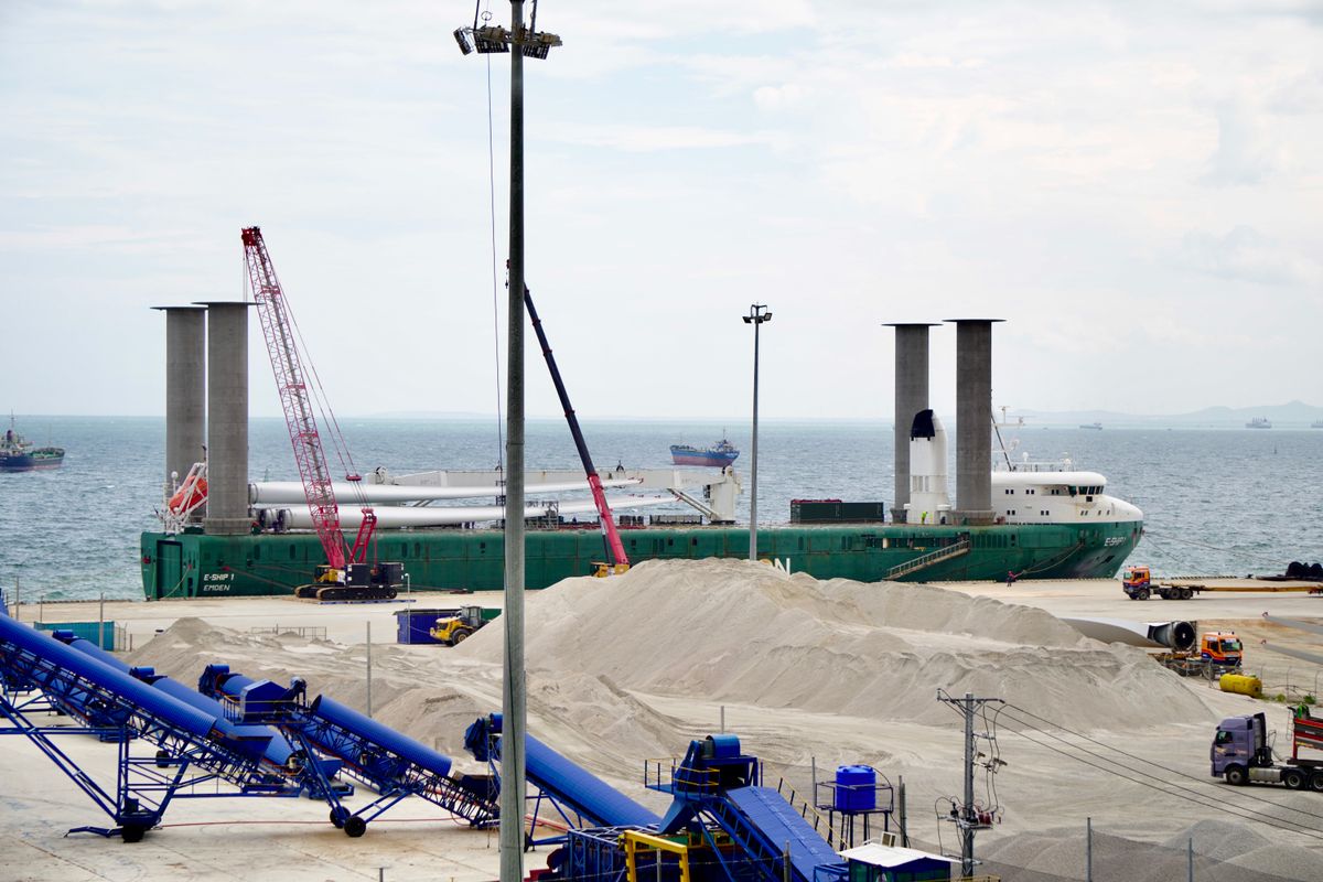 Commercial cargo ship alongside an industrial berth