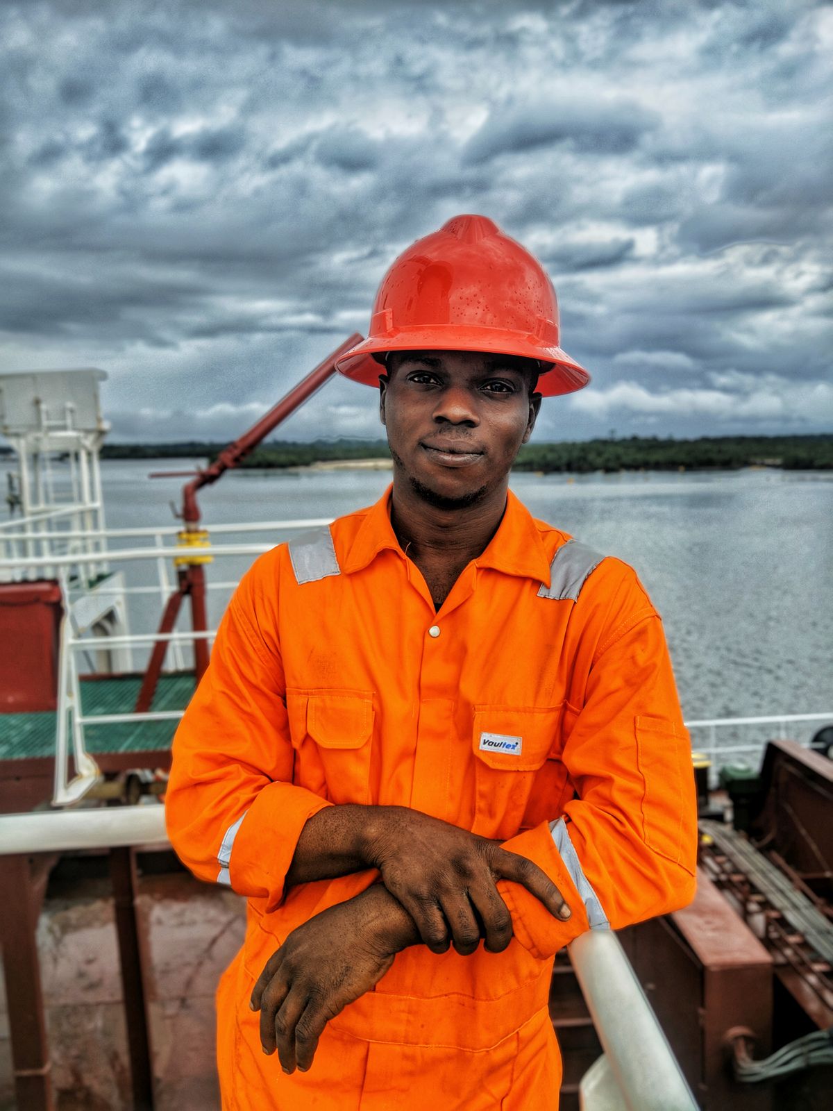 Maritime worker wearing protective equipment on a ship deck