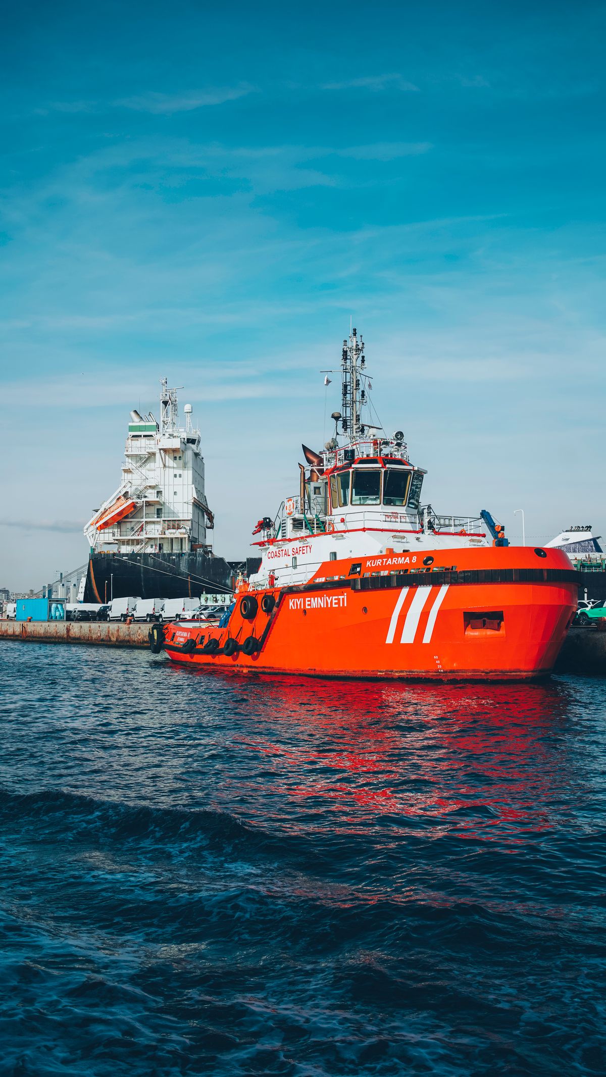 Tugboat assisting a cargo vessel in harbour
