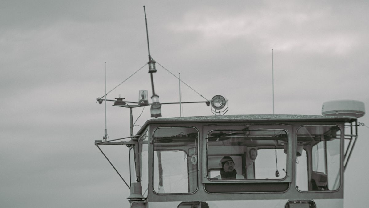 Captain overseeing navigation from a ship bridge
