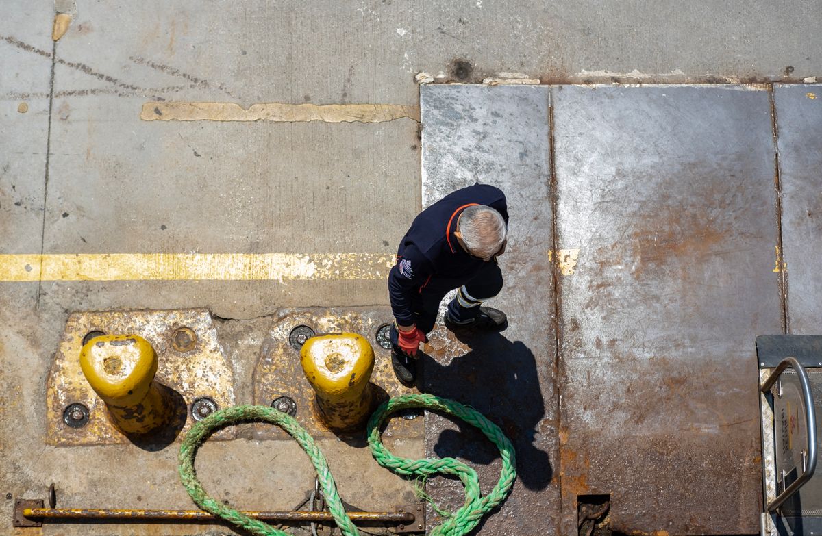 Dock worker handling a mooring rope